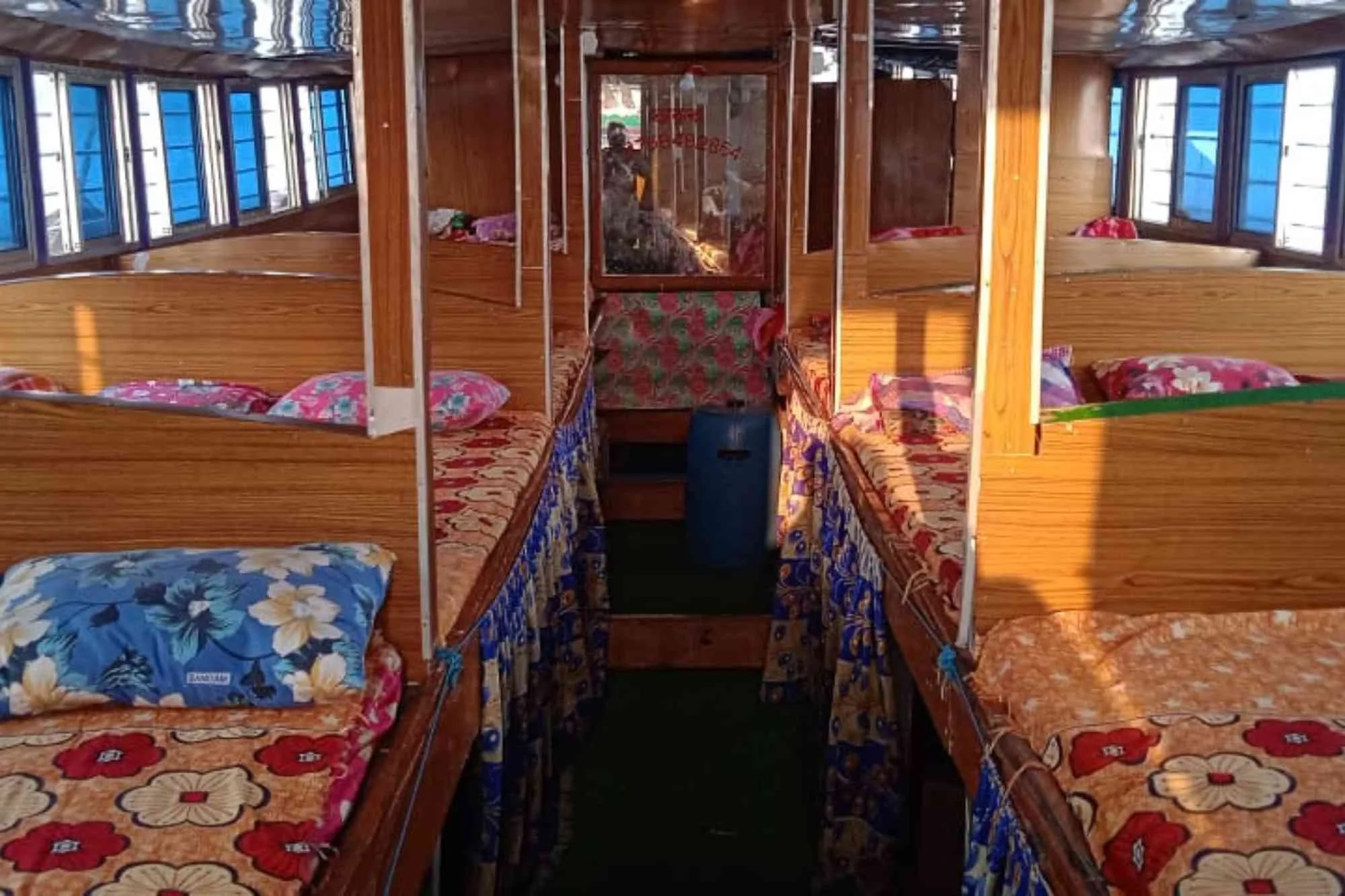 Inside view of a Sundarban river boat with bed and accommodations.