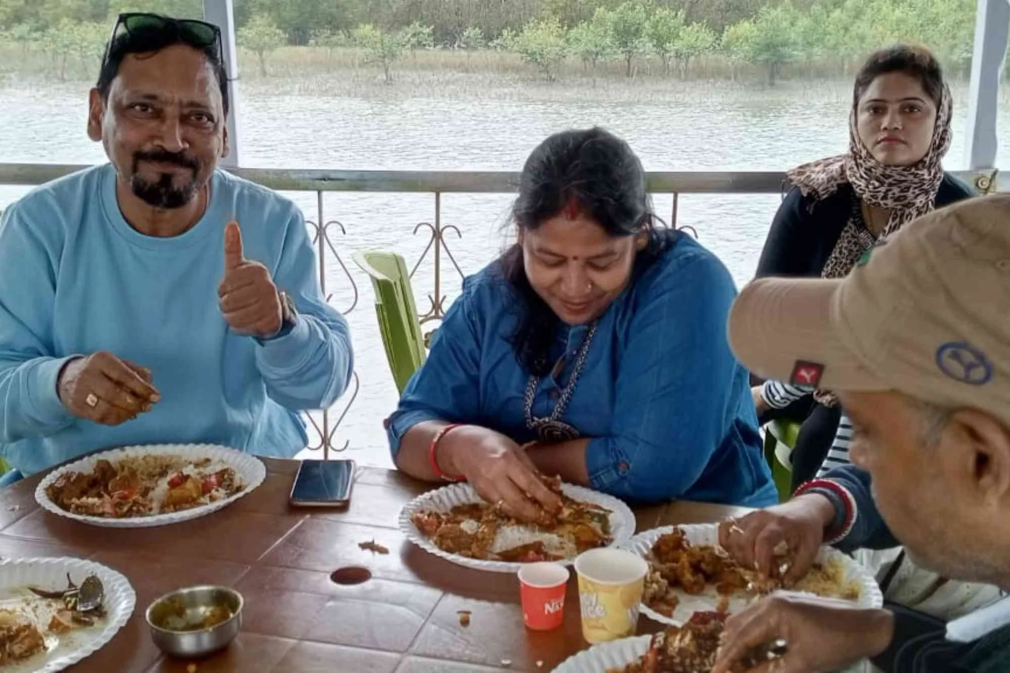 Sundarban Mondal Travels tourists eating food during river boat rafting.