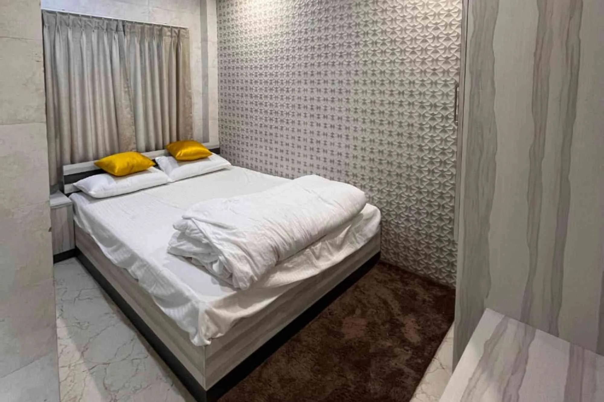 Vip hotel room with clean blanket and beautiful wall decoration and marbel floor for sundarban tour from canning