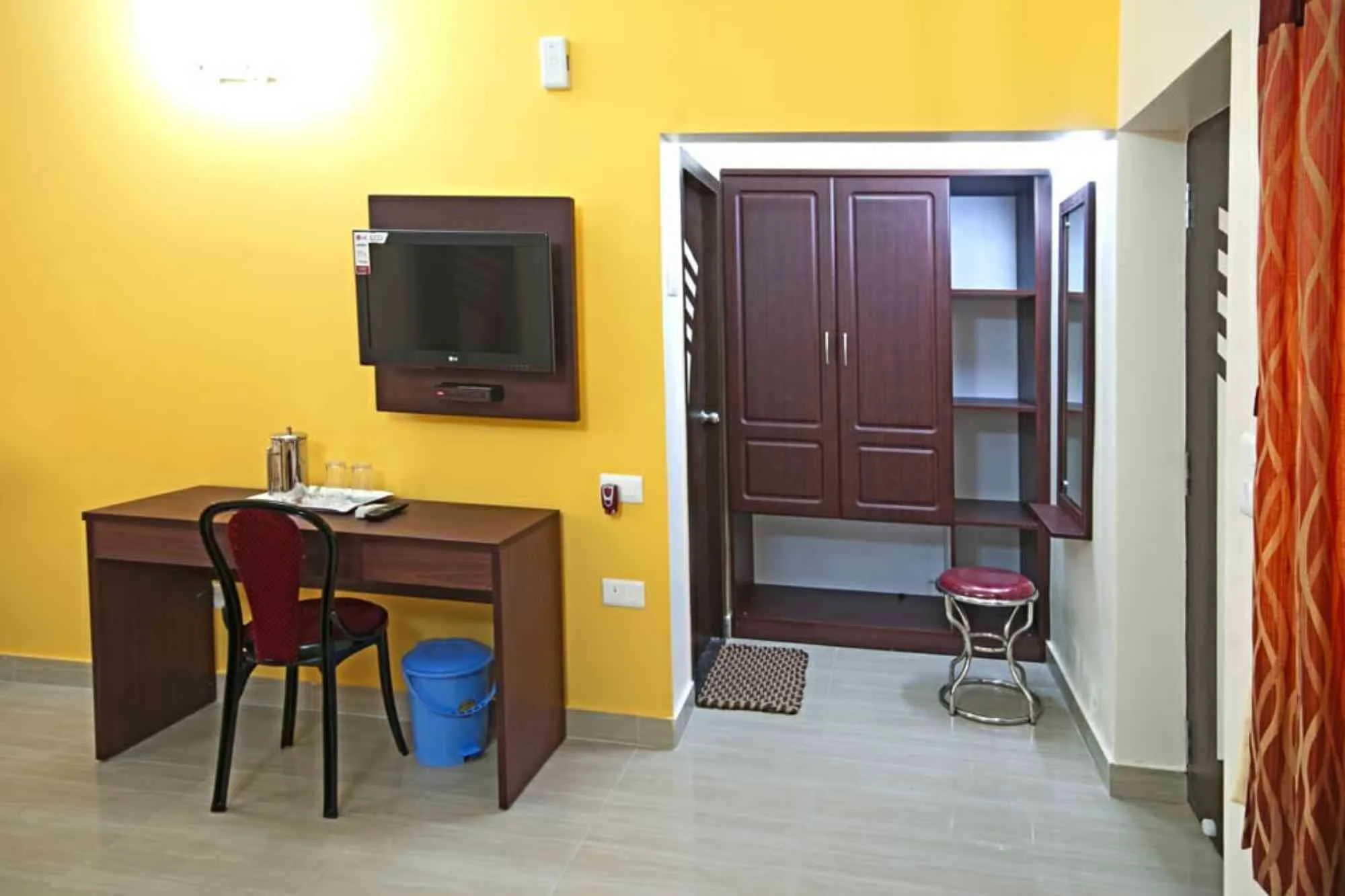 Inside view of Sundarban Mondal Travels hotel room with bed, TV, and accommodations.