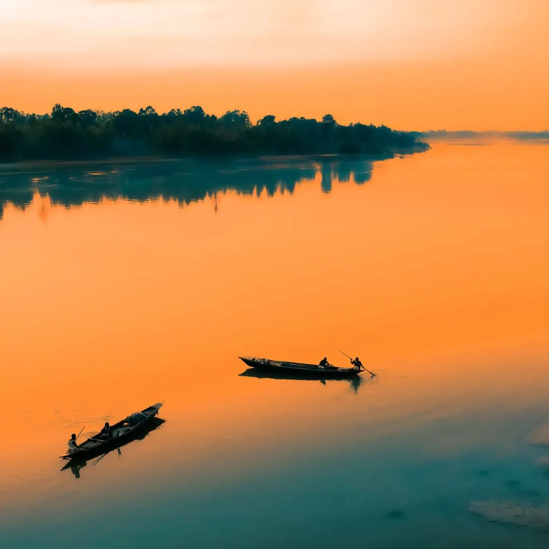 Foreign tourists enjoying a small boat ride in Sundarban